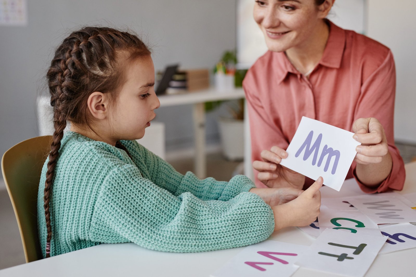 Little girl learning the English alphabet